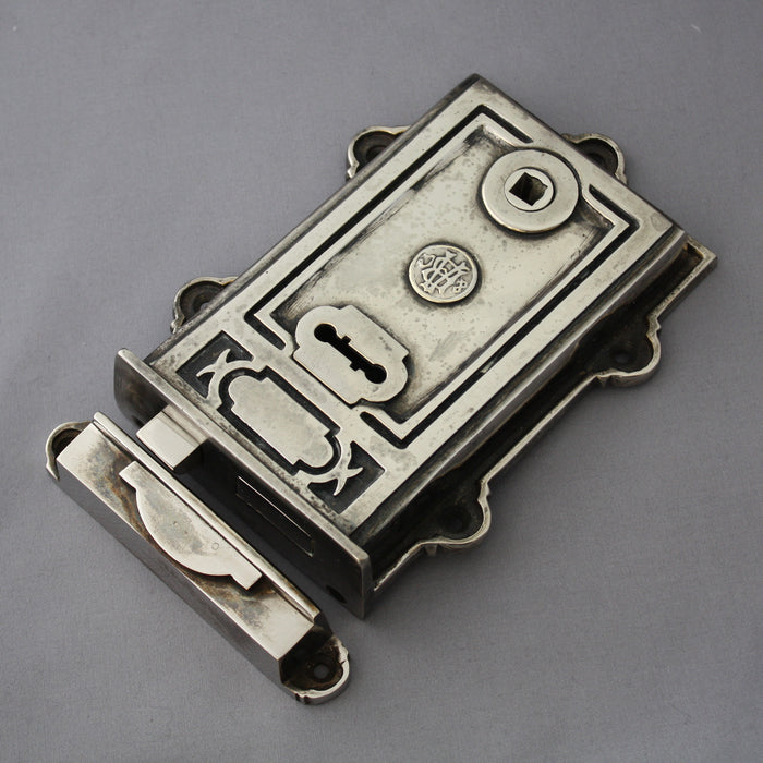 Victorian style nickel surface mounted rim lock