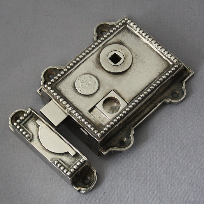 Regency style nickel surface mounted rim latch